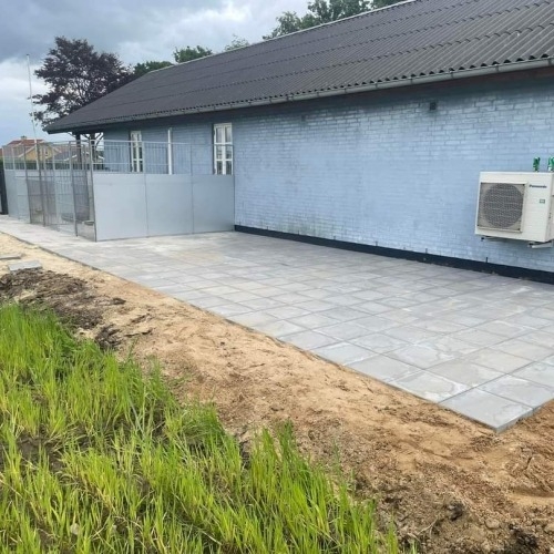 Ny terrasse i Brørup med flisearbejde langs facade og indhegnet område.