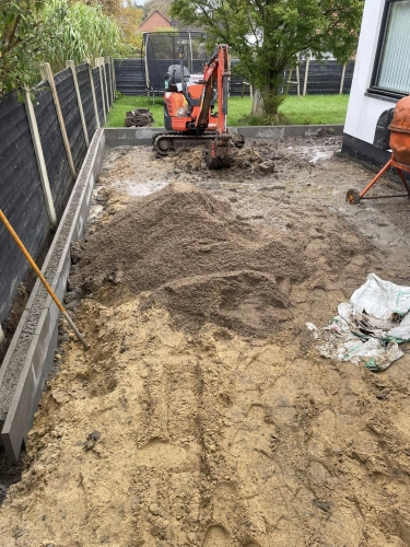 Forberedelse til flisearbejde, maskineri og grus til planering.