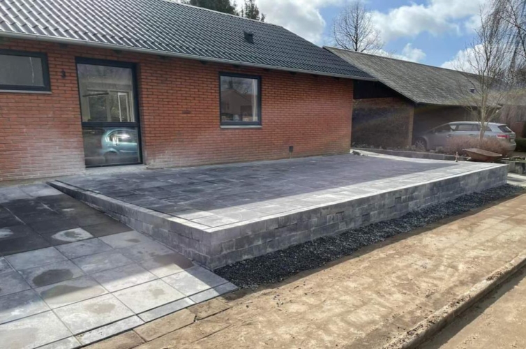 Hævet terrasse med flot ny flisebelægning ved indkørsel i Gørding.