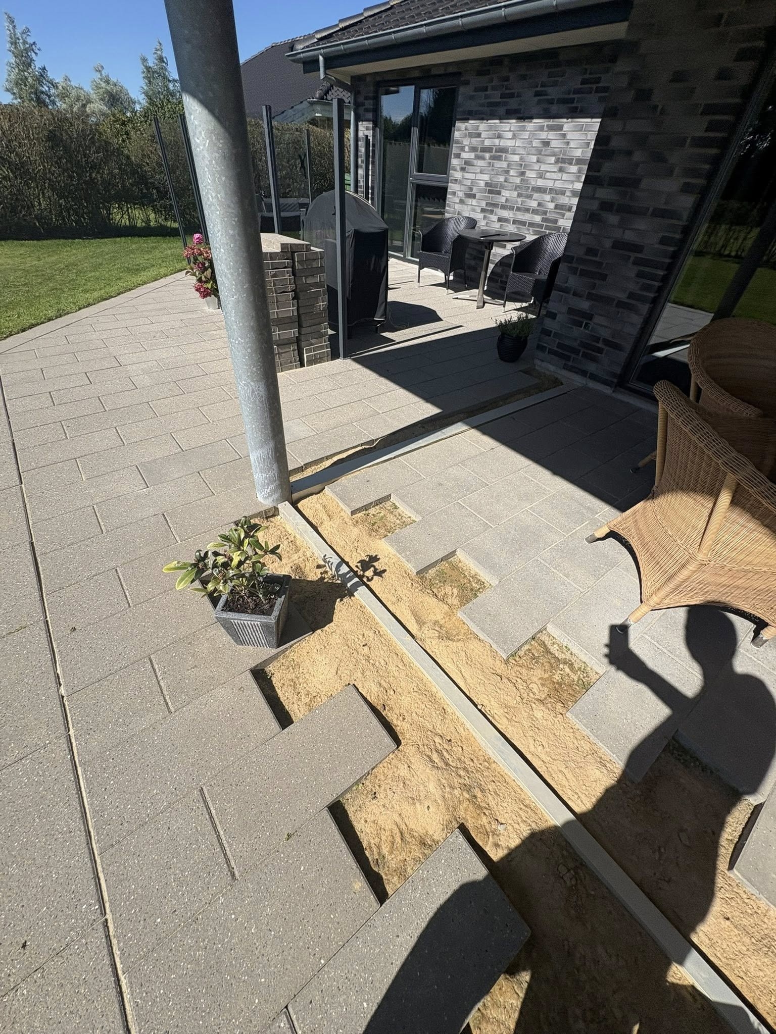 Flisearbejde med tilpasning af fliser omkring stolper og terrasse i Bramming.